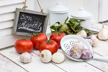 White Kitchen With Garlic And Tomatoes And Sign Bon Appetit