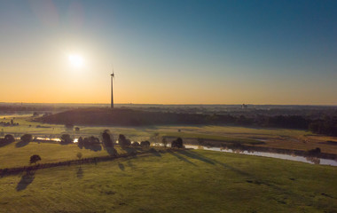 Fototapeta na wymiar Die Wiesen an der Ruhr in Duisburg im Frühnebel bei Sonnenaufgang aus der Luft