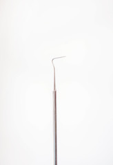 Stainless steel dental tool on white background 