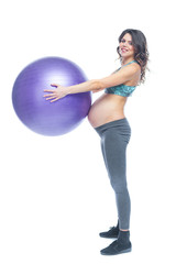 Fototapeta premium Portrait of a beautiful young pregnant woman exercises with fitball. Working out and fitness, pregnancy concept. Isolated white background.