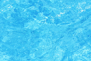 Background of clean blue rippled water in a hotel swimming pool
