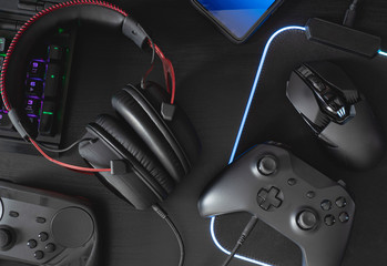 gamer work space concept, top view a gaming gear, mouse, keyboard, joystick, headset, mobile...