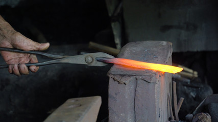 Hot metal is processed on the anvil in the forge. Anvil in the forge