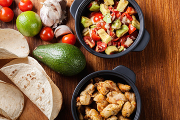 Ingredients ready for preparing chicken tacos with salsa made fr