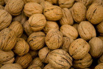 group of walnuts, brown, with still shell, dried, fresh, at local fruit market, agriculture, food, diet, snack, vitamins, nourishment, nutrition, summer, background, Milan, Italy