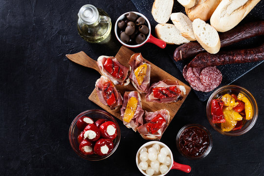 Spanish tapas with slices jamon serrano and grilled pepper. Also