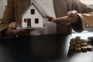 Car and House model with agent and customer discussing for contract to buy, get insurance or loan...