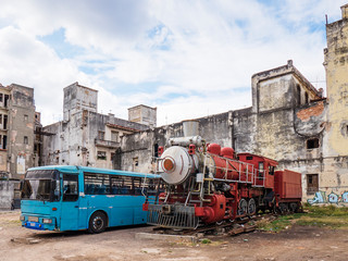 An old bus and locomotive by the chinese neighbourhood in La Habana, Havana, Cuba.