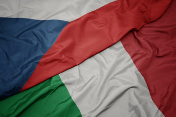 waving colorful flag of italy and national flag of czech republic.