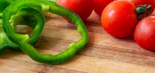 juicy bell pepper chopped with rings and cherry tomatoes for salad preparation