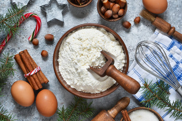 Fototapeta na wymiar Ingredients for Christmas baking: flour, eggs, sugar, nuts, cinnamon, spices. Top view.