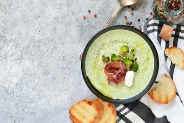 Broccoli cream soup on a concrete background. View from above.