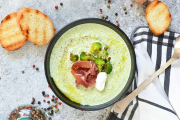 Broccoli cream soup on a concrete background. View from above.