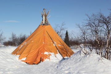 orange house in winter forest