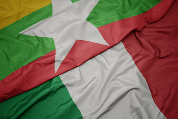 waving colorful flag of italy and national flag of myanmar.