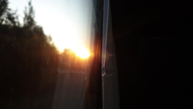 Train movement in the early morning. The sun in the window of the train. Dawn.