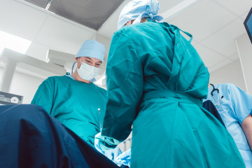 Medical doctors performing operation in hospital