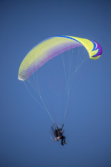 motor glider in cloudless blue sky
