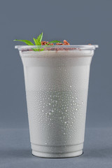 Milkshake with mint and chocolate chips on a gray background
