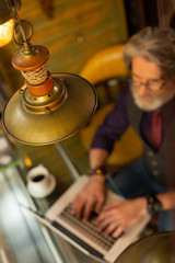 Man working in a cafe with specific interior.