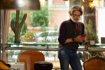 Concentrated man reading news on his smartphone.