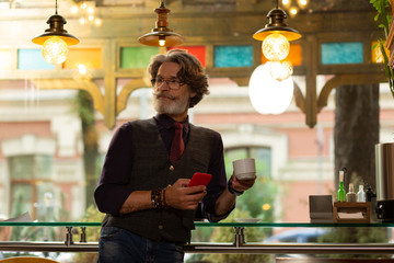 Man noticing one of his friends in the cafe.