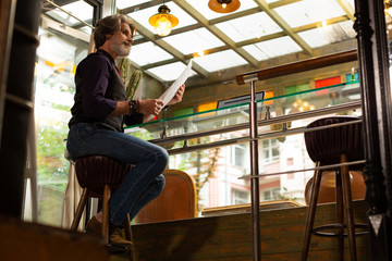 Fototapeta premium Man thinking of trying something new in a coffee shop.