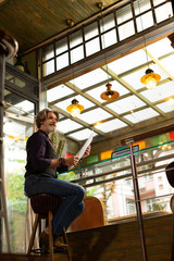 Cafe visitor waiting for a waiter before ordering.