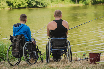 Handicapped men fishing at a lake. Wheelchair. Camping.