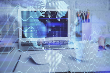 Stock market graph on background with desk and personal computer. Multi exposure. Concept of financial analysis.