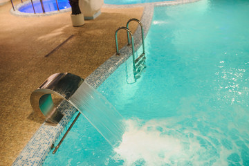 the interior of the aquazone in a spa salon, swimming pools and a water fall