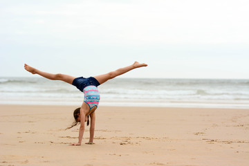 Rhythmic gymnast at beach. Sport, training, fitness, yoga, active lifestyle concept