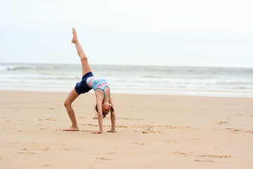 Rhythmic gymnast at beach. Sport, training, fitness, yoga, active lifestyle concept