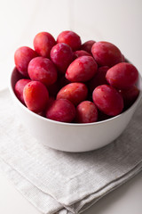Naklejka na ściany i meble red plums in a bowl