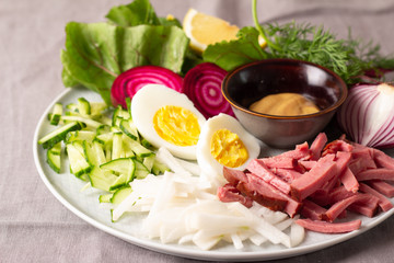 ingredients for a cold soup of greens and beets on a gray plate