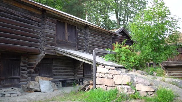 Overview of old wooden farmhouse buildings in historical museum
