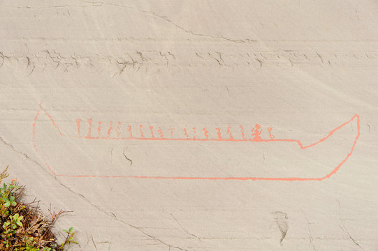 Rock art in Alta Fjord, Norway. Ancient symbols, real drawing,  texture in stone. Red ocher paint. Human preys on animals deer.  Group of petroglyphs, dating from c. 4200 to 500 B.C.