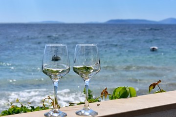 glass of white wine on the beach