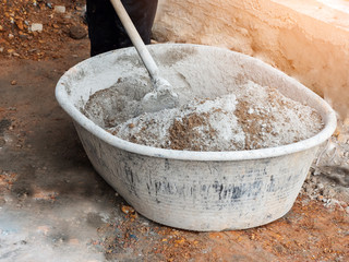 Worker mix Cement  concrete in basin in construction site