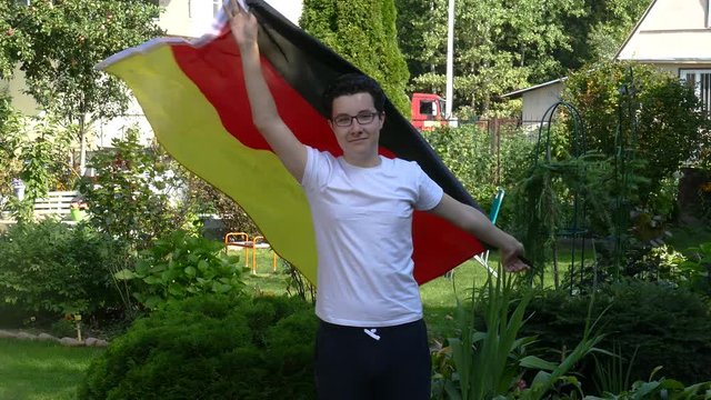 Young people waving a flag outdoors