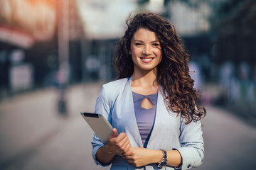 Young business woman using digital tablet outdoor