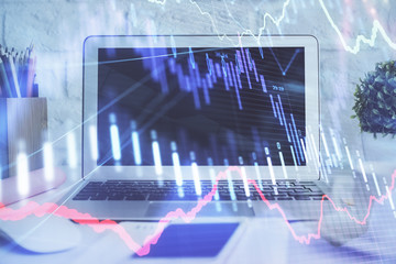Forex graph hologram on table with computer background. Multi exposure. Concept of financial markets.