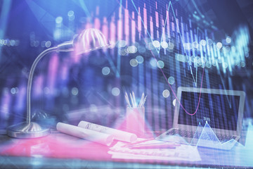 Stock market graph and table with computer background. Double exposure. Concept of financial analysis.