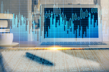 Double exposure of graph and financial info and work space with computer background. Concept of...