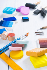 ink pads, brushes and carving cutters on white wood table