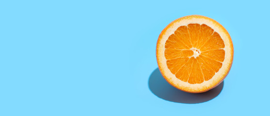 Ripe juicy delicious orange on blue background. Healthy eating and dieting concept. Copy space. Free space for your text