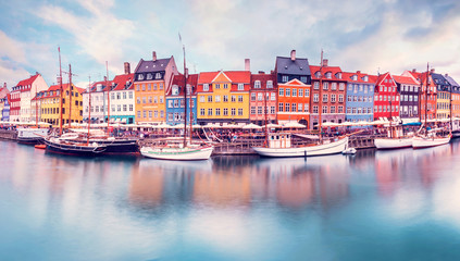 Unmatched magical fascinating landscape with boats in a famous Nyhavn in the capital of Denmark Copenhagen. Exotic amazing places. Popular tourist atraction. - obrazy, fototapety, plakaty