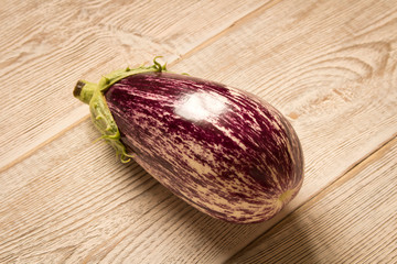 Fresh purple eggplant on wooden table. Natural food.