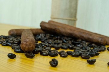 coffee beans on wooden table with cigars
