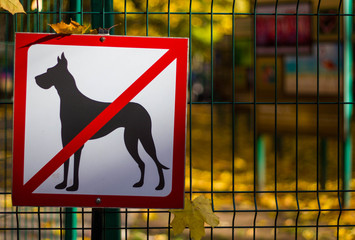 The prohibition sign that dogs are not allowed. White with red the seedling on the fence with dogs...